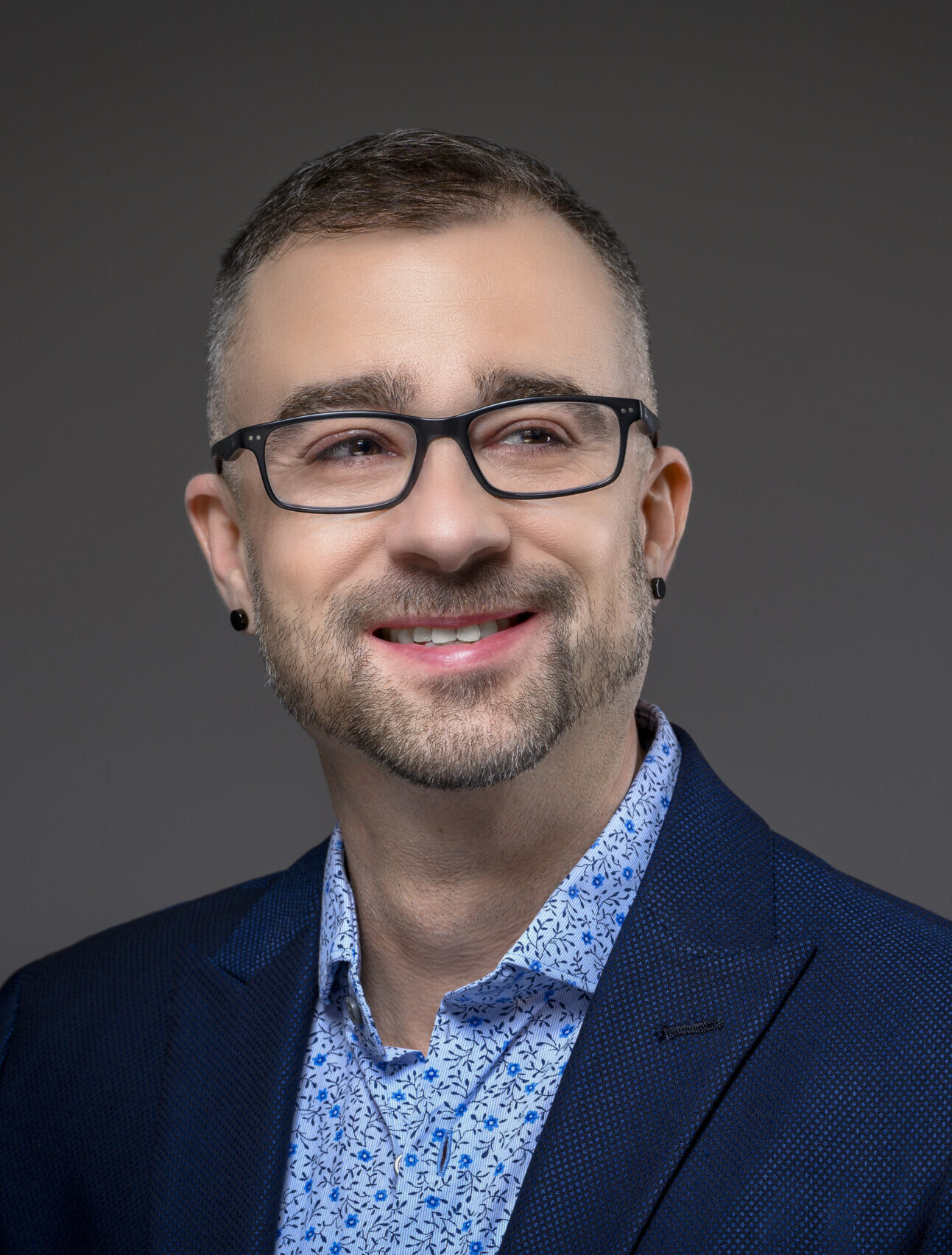 Professional photo of Zac Winner in blue suit on gray gradient background